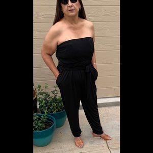 Black strapless jumpsuit with pockets.